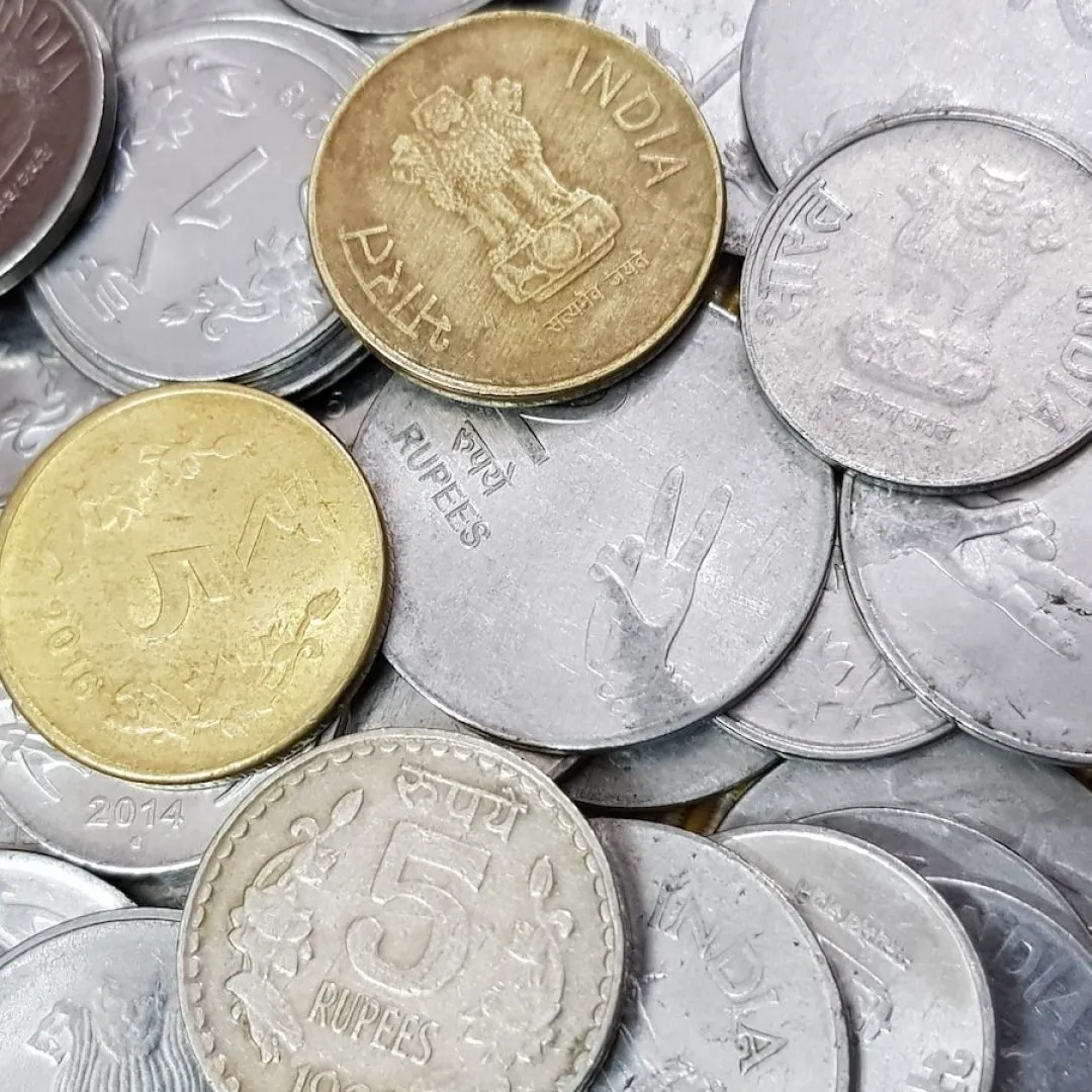 a pile of british coins sitting on top of each other